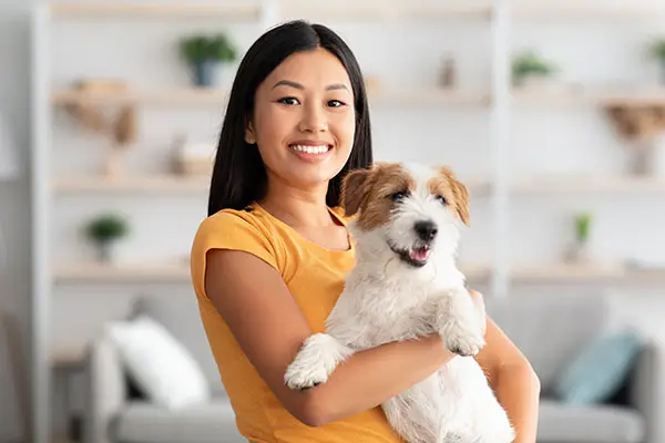 Woman and her puppy enjoying a live video consultation online training session